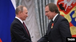 Russian President Vladimir Putin (left) bestows an award on St. Petersburg House of Music artistic director Sergei Roldugin during a ceremony at the Kremlin in Moscow in 2016.