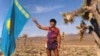 Kazakhstan. Marathon runner Marat Zhylanbayev / Zhylanbaev with the Kazakh flag in the Nevada desert. USA, 1994.