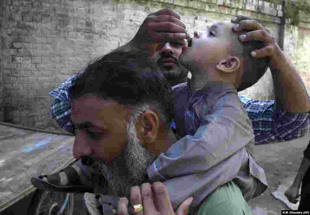 A health worker gives a polio vaccine to a child in Lahore, Pakistan, on September 24. (AP/K.M. Chaudary)