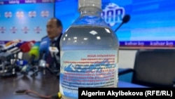 A potentially toxic aconite infusion is seen at a press conference in Bishkek on April 16.