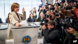 Moldova's President Maia Sandu casts her vote in Chisinau on October 20. "Criminal groups working with foreign forces have attacked our country with tens of millions of euros, lies, and propaganda...to keep our country trapped in uncertainty and instability," she said.