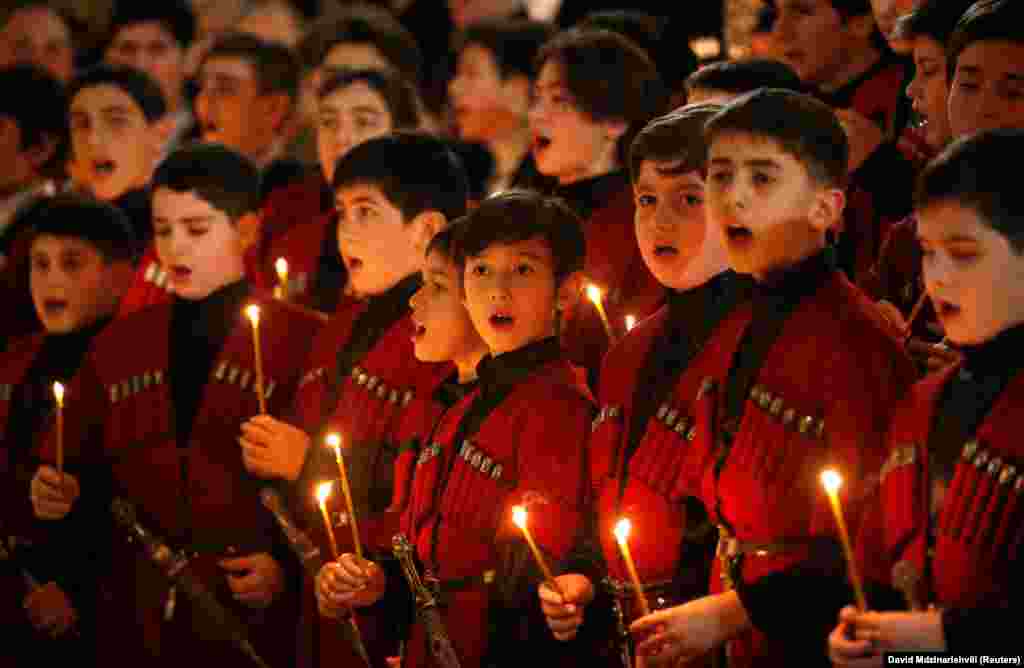 Children sing a hymn during a midnight Christmas service at the Holy Trinity Cathedral in Tbilisi, Georgia, on January 6. (Reuters/David Mdzinarishvili)