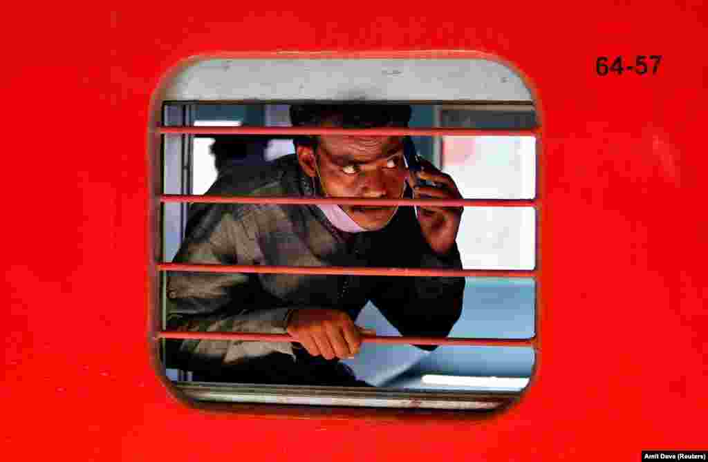 A migrant worker, who was stranded in the western Indian state of Gujarat due to a coronavirus lockdown, looks out from a train that will take him to his home state of eastern Bihar. (Reuters/Amit Dave)