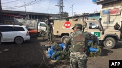 Pakistani security officals inspect the site of a bomb explosion at a vegetable market in Parachinar city, the capital of Kurram tribal district on the Afghan border on January 21. 