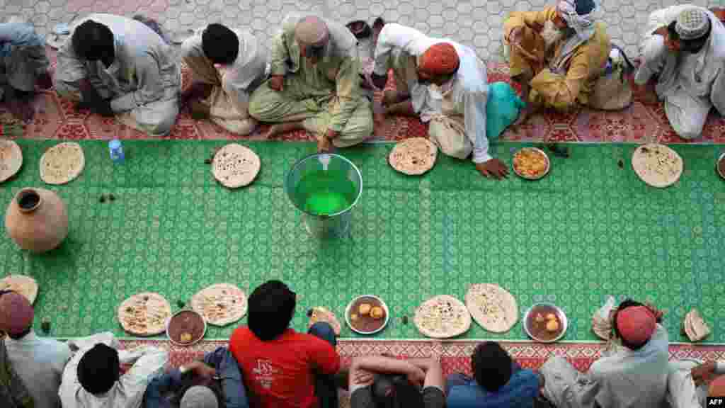 Pakistani Muslims wait to break their fast in Quetta on July 25. Muslims fasting in the month of Ramadan must abstain from food, drink, and sex from dawn until sunset, when they break the fast with the meal known as iftar. (AFP/Banaras Khan)