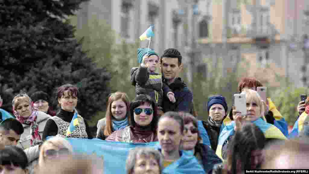 Campaign activists carry Ukrainian flags...