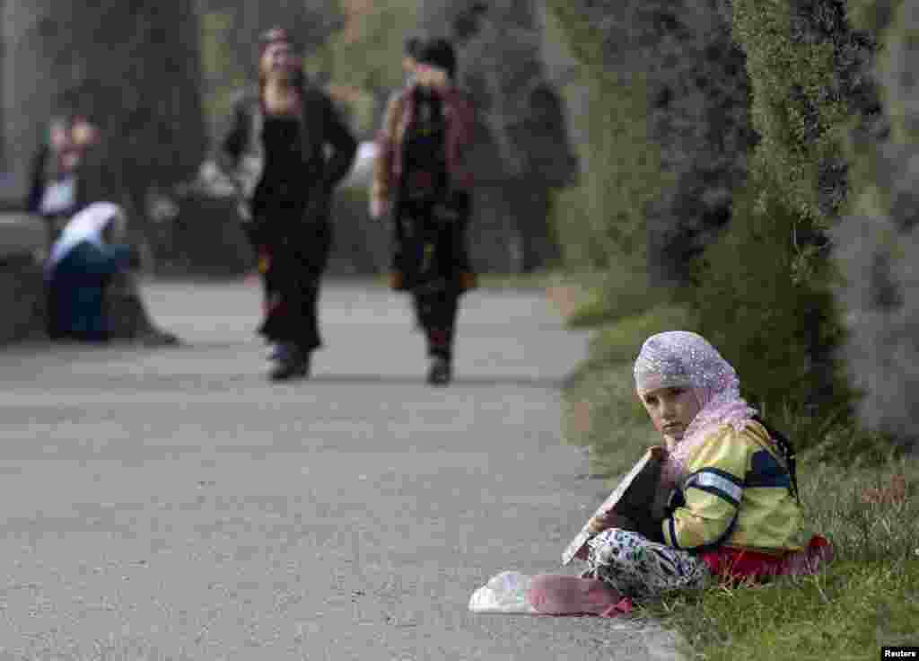 A girl begs for money in Dushanbe, Tajikistan, on November 3. (Reuters/Nozim Kalandarov)