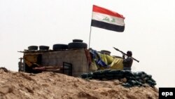 An Iraqi soldier holds a rocket-propelled grenade during a military operation near Ramadi on June 1.