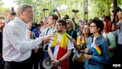 EU Commissioner for Enlargement and European Neighborhood Policy Stefan Fuele greets members of the LGBT community during a march for human rights in downtown Chisinau on May 19.