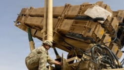 A US Army air defense artilleryman conducts maintenance on an MIM-104 Patriot missile system at an undisclosed location in the Middle East.