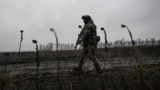 A soldier of Ukraine's National Police Special Purpose Battalion patrols a frontline position near Pokrovsk in the Donetsk region on November 20.