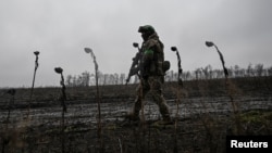A soldier of Ukraine's National Police Special Purpose Battalion patrols a frontline position near Pokrovsk in the Donetsk region on November 20.