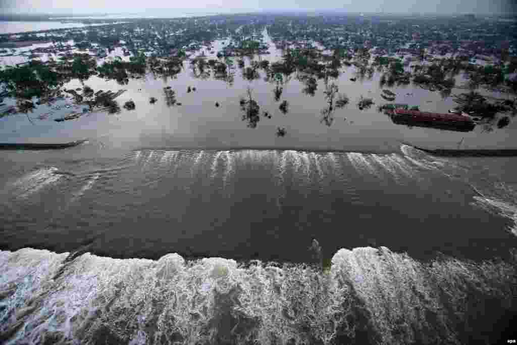 Water spills over a levee along a canal just outside New Orleans on August 30, inundating parts of the city.