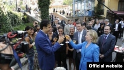 Georgian President Mikheil Saakashvili and U.S. Secretary of State Hillary Clinton toast good relations in Tbilisi in July.
