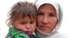 A woman and her child await their turn to get drinking water from a community tap in Baghlan, in northern Afghanistan, earlier this month. Years of conflict and drought have left large sections of the populations without access to clean water.