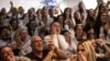 Dana Shem Tov (center) the sister of Israeli hostage Omer Shem Tov reacts as she watches with others his televised release by Hamas militants at the family home in Tel Aviv on February 22.