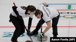 Russian curling medalist Aleksandr Krushelnitsky and wife Anastasia Bryzgalova compete in Olympic curling.