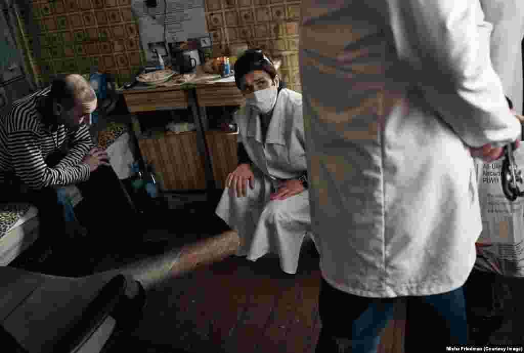 Yana, an outreach worker, visiting an HIV positive patient being treated for tuberculosis in Donetsk. HIV sufferers are particularly susceptible to diseases such as TB, which is currently making a comeback in Ukraine's war zones.