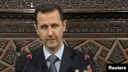 Syrian President Bashar Al-Assad addresses the parliament in Damascus on March 30.