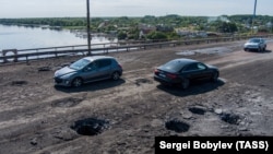 The Antonivsky Bridge across the Dnieper River, which connects occupied Kherson with the left bank, shows damage after Ukraine's first strikes targeted it on July 20.