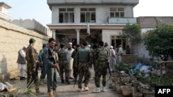 Afghan security forces inspect the site of a suicide bombing that targeted a gathering of the local tribal elders in the Chaparhar district of Nangarhar Province on October 31.