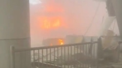 Fire burns in  in the aftermath of air strikes at Kuwait International Airport in Kuwait City on June 3.