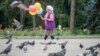 KAZAKHSTAN -- An elderly woman sells balloons in a park in Almaty, Kazakhstan June 28, 2017