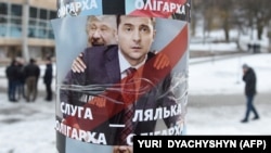 A placard depicting Ukrainian entertainer and presidential candidate Volodymyr Zelenskiy (right) as a puppet for oligarch Ihor Kolomoyskiy in Lviv in February.