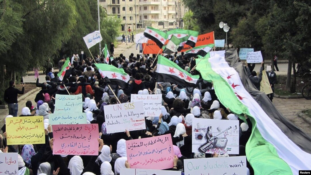 Antigovernment demonstrators march in the town of Homs, one of the most restive Syrian cities, in late November.