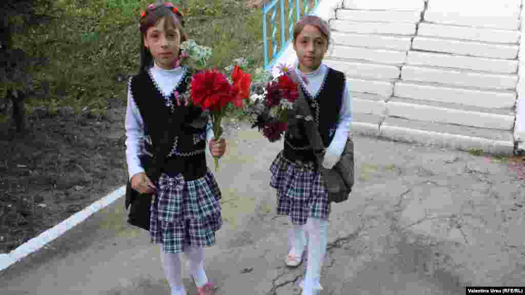 Children carry roses at the start of the school year in Balanesti, Moldova.