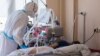 A medic attends a patient at a special unit for COVID-19 patients in a Russian hospital. (file photo)