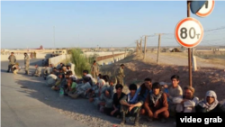 Afghan soldiers and militia members who crossed into Tajikistan following fighting with the Taliban on June 25. (screen grab)