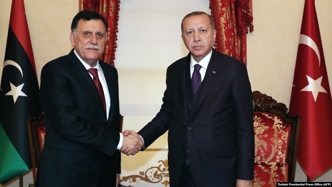 Turkish President Recep Tayyip Erdogan (right) meets with Fayez al-Sarraf, the head of the Tripoli-based Government of National Accord, in Istanbul on December 15.