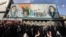 People walk past a banner depicting Iran’s Supreme Leader Ayatollah Ali Khamenei and late leader Ruhollah Khomeini in Tehran on January 14.