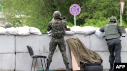 A Ukrainian soldier holds a rocket launcher as he guards a checkpoint near the eastern city of Slovyansk on May 5.