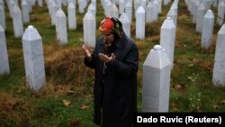 Hatidza Mehmedovic prays near the graves of her two sons and husband at the Memorial Center in Potocari, near Srebrenica, on November 14, 2017.