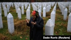 Гатіджа Мехмедович молиться біля могил двох її синів та чоловіка поблизу Сребрениці (Листопад 2017 року).