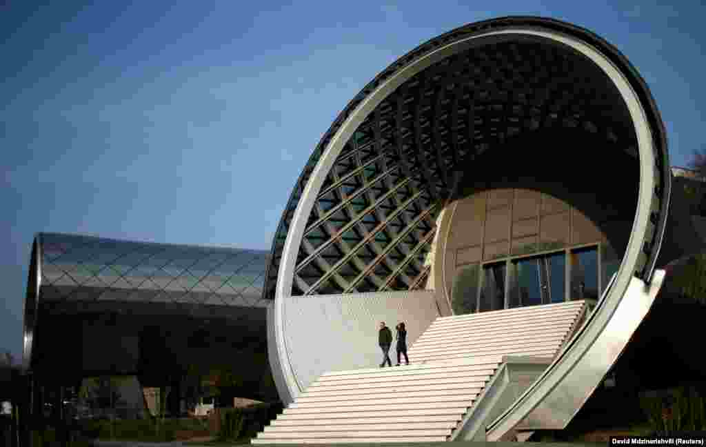 A couple walks downstairs at a concert hall under construction in the Georgian capital, Tbilisi. (Reuters/David Mdzinarishvili)