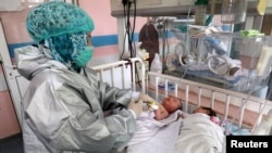 An Afghan nurse cares for newborn children who lost their mothers during an attack at a hospital in Kabul. (file photo)