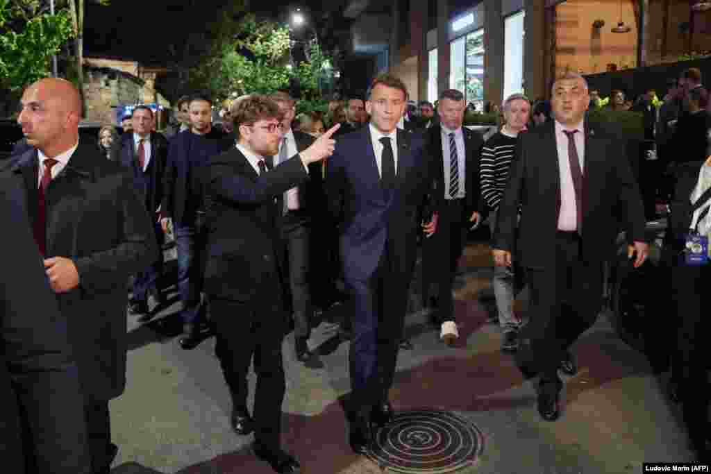 On the evening of May 3, before the summit got underway, French President Emmanuel Macron (center) walked through central Yerevan with France's Ambassador to Armenia, Olivier Decottignies (center left).