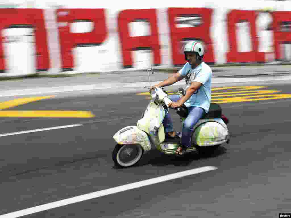 A man rides a scooter past graffiti on a wall reading "Justice" in Belgrade on July 22. Later that day the International Court of Justice affirmed Kosovo's 2008 unilateral declaration of independence from Serbia, saying it did not violate international law.Photo by Marko Djurica for Reuters