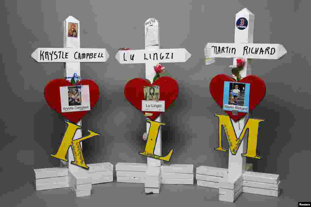 Crosses for the three people who died in the Boston Marathon bombings: Krystle Campbell, 29, Lu Lingzi, 23, and Martin Richard, 8. These crosses appeared at a spontaneous makeshift memorial that sprang up near the site of the deadly blasts in the days after the attack. 