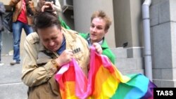 A man (right) attacks a gay rights activist in central Moscow. Antigay attitudes are still quite prevalent in much of Russia. 