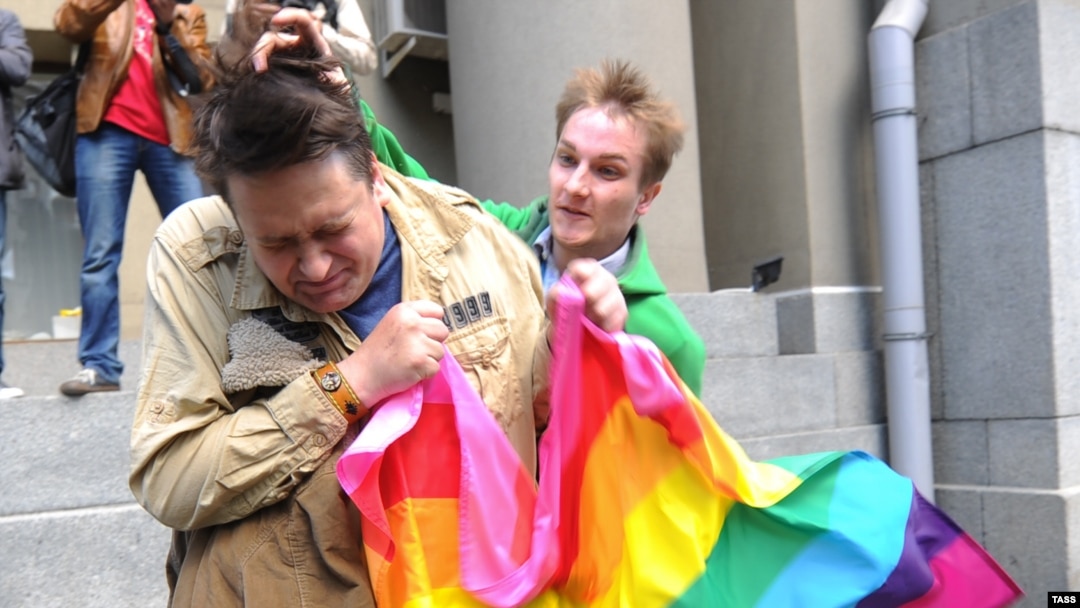 A man (right) attacks a gay rights activist in central Moscow. Antigay attitudes are still quite prevalent in much of Russia. 