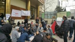 Protesters in front of a Caspian bank branch demand their deposits.