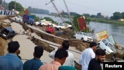 People gather near a damaged road after a 5.8 magnitude earthquake in Mirpur, Pakistan, on September 24. (file photo) 