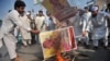 Members of a Pakistani trade union burn posters of U.S. President Donald Trump at a protest in Peshawar on August 30.