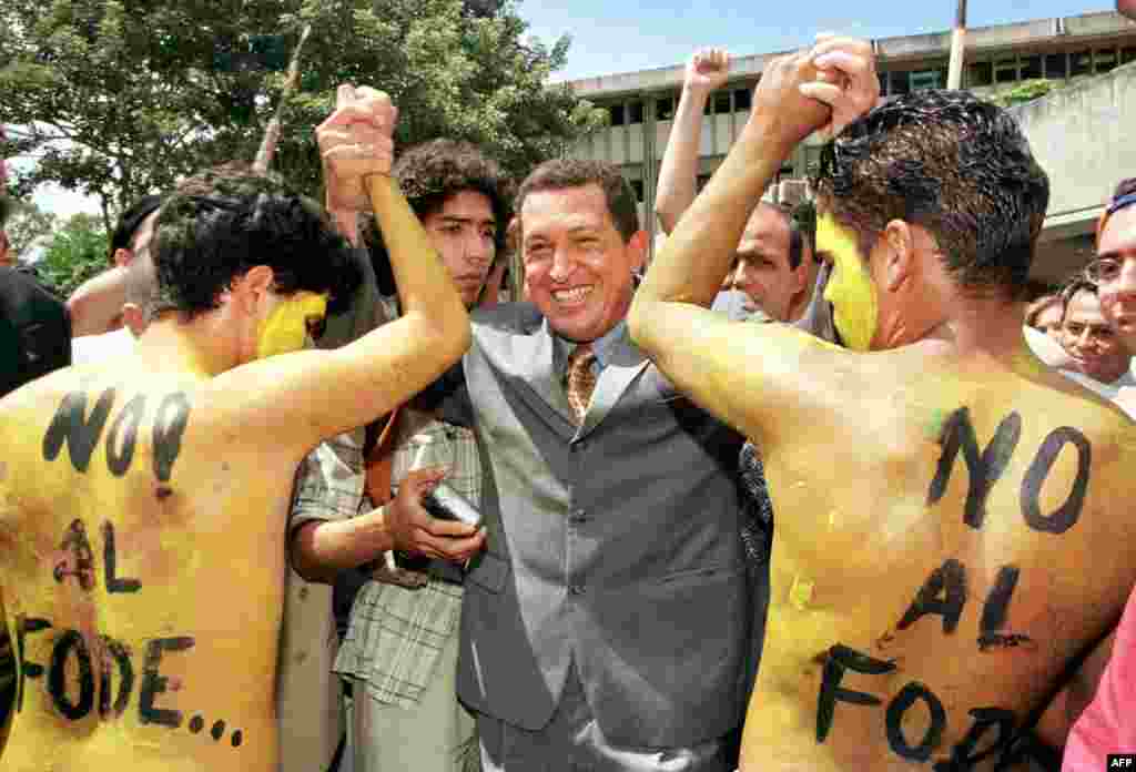 Chavez is greeted by students in Caracas as he leaves Simon Bolivar University in September 1998.