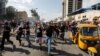 IRAQ -- Demonstrators run during a protest over corruption, lack of jobs, and poor services, in Baghdad, Iraq October 25, 2019. 