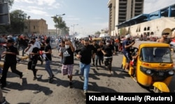 Demonstrators run during a protest over corruption, lack of jobs, and poor services, in Baghdad, Iraq October 25, 2019.